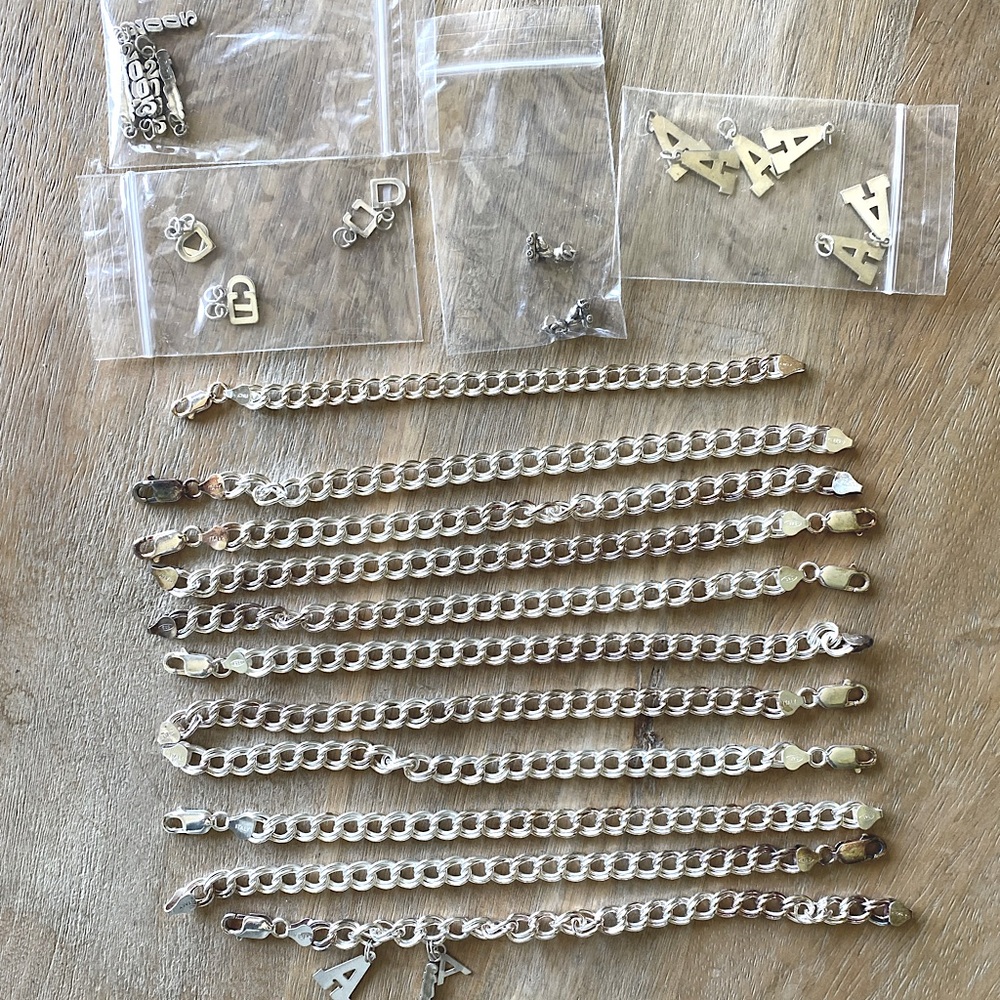 Group of Eleven .925 Sterling Silver Charm Bracelets w random charms